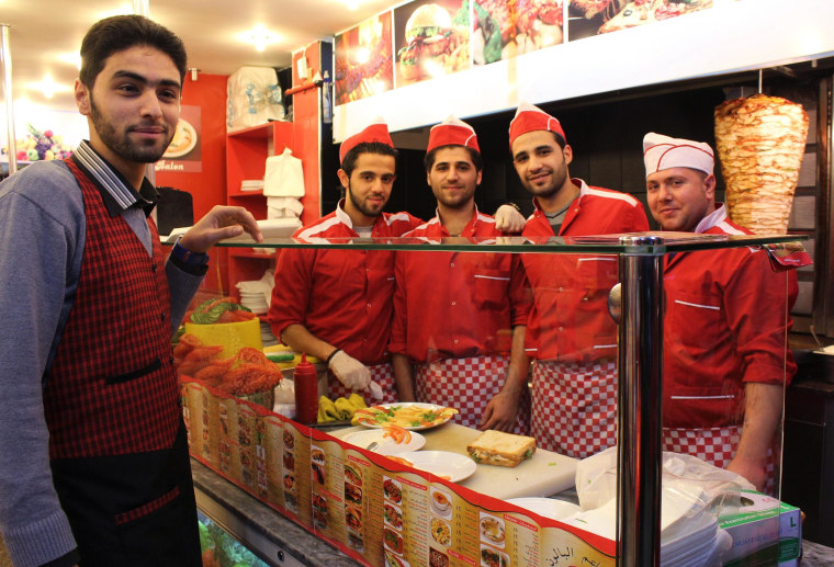 Image: Servers at the new Istanbul location of a Syrian fast food chain called Baloon, pose for a photo