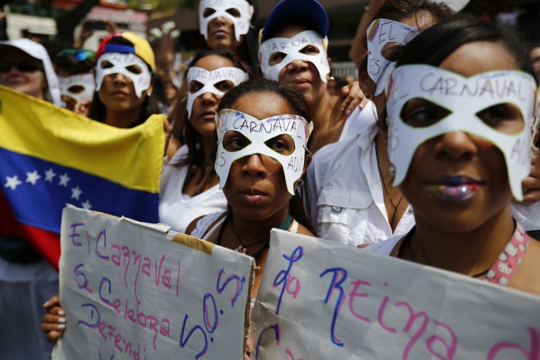 Image: Opposition demonstrators wearing carnival masks take part in a women's rally against Nicolas Maduro