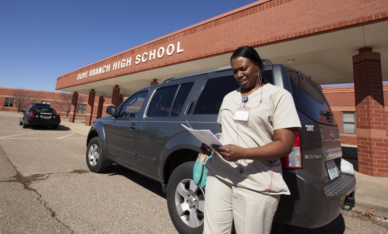 Image: Janet Hightower walks out of Olive Branch High School after a meeting with the administration about getting her son Dontadrian Bruce, back into school.