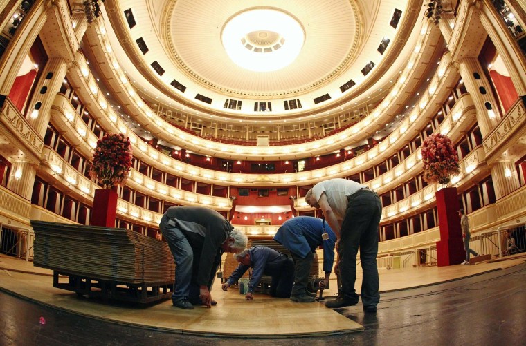Image: Workers lay the dance floor in the opera house in Vienna