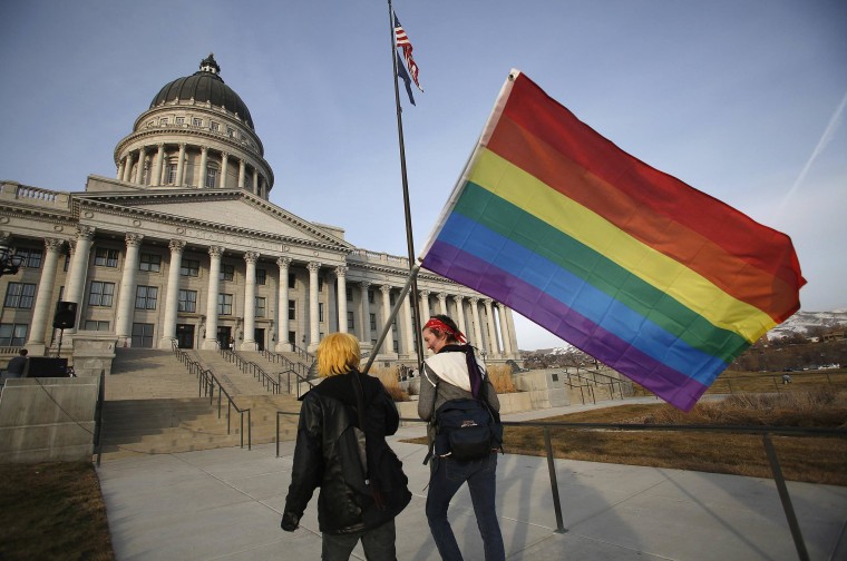 Image: Corbin Aoyagi and Jerusha Cobb walk to join supporters of same-sex marriage rally at Utah's State Capitol building in Salt Lake City.