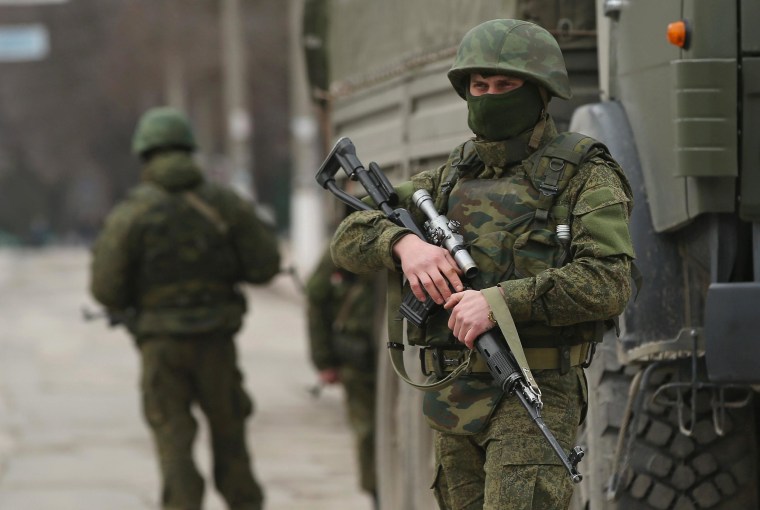 Image: Heavily-armed soldiers displaying no identifying insignia maintain watch in a street in the city center on March 1, 2014 in Simferopol, Ukraine.
