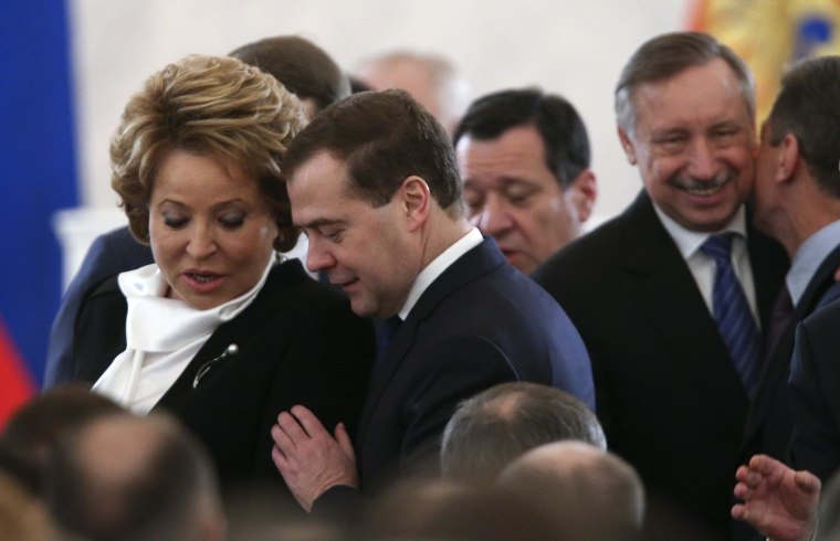 Russia's Prime Minister Dmitry Medvedev (R) talks to Federation Council Speaker Valentina Matviyenko (L) before President Vladimir Putin delivers his annual state of the nation address at the Kremlin in Moscow, Dec. 12, 2013. 