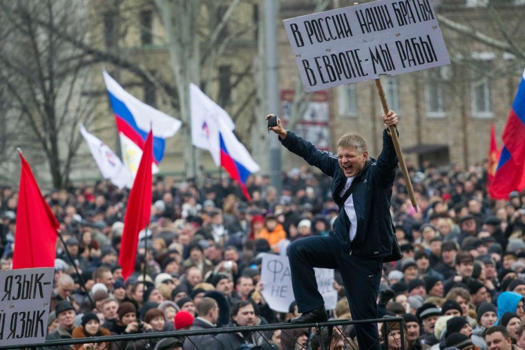 Image: Pro-Russian protesters with Russian flags take part in a rally in central Donetsk