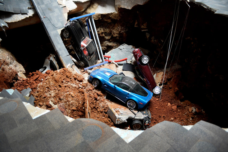 A view of a sinkhole that opened up in the Skydome showroom, Wednesday, Feb. 12, 2014, at the National Corvette Museum in Bowling Green, Ky. Eight display cars were swallowed by the hole. (AP Photo/Michael Noble Jr)