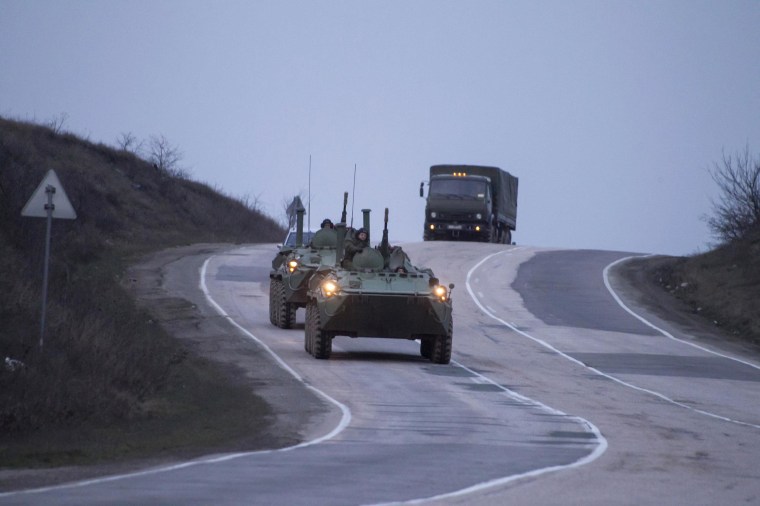 Image: Russian military armored personnel carriers (APC) drive on the road from Sevastopol to Simferopol