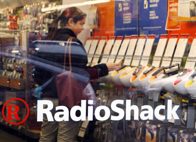 Image: A shopper looks over the mobile phones displayed at a RadioShack store in Cambridge