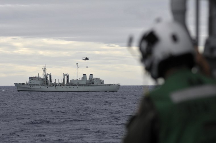 An SH-60B Sea Hawk helicopter prepares to unload materials aboard Canada's naval vessel HMCS Protecteur. 