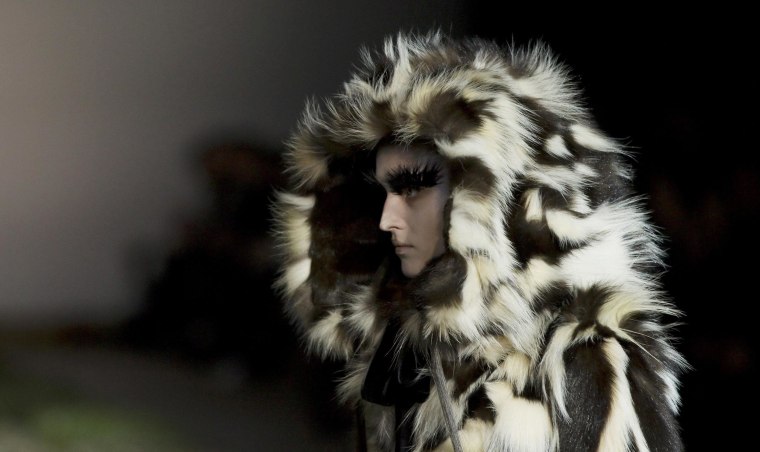 Image: A model presents a creation by British designer Sarah Burton from her Fall/Winter 2014-2015 women's ready-to-wear collection for fashion house Alexander McQueen during Paris Fashion Week