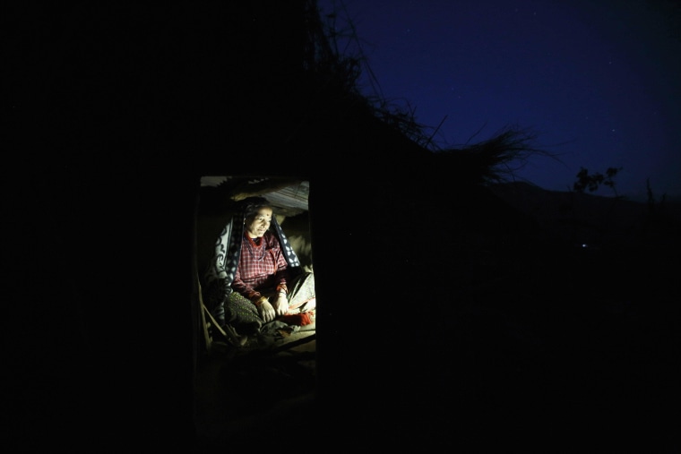Image: Dhuna Devi Saud prepares to sleep inside a Chaupadi shed
