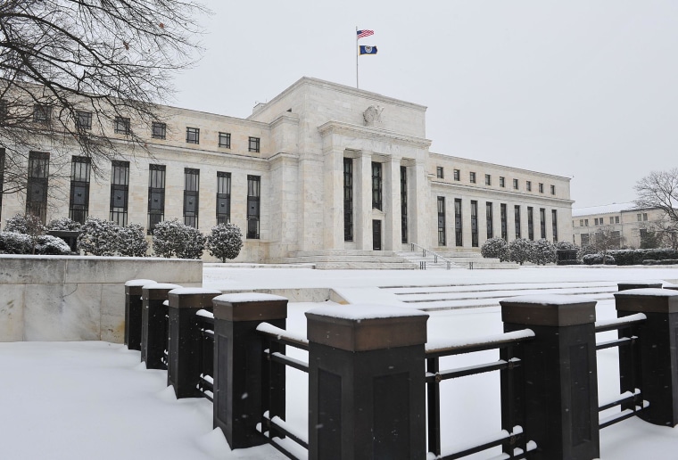 The Federal Reserve is seen during a snow storm. Severe winter weather hit economic activity in January and early February, the central bank said.