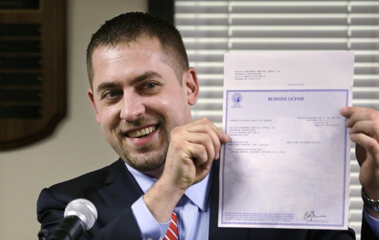 Image: Sean Green received the first legal marijuana license in Washington state.