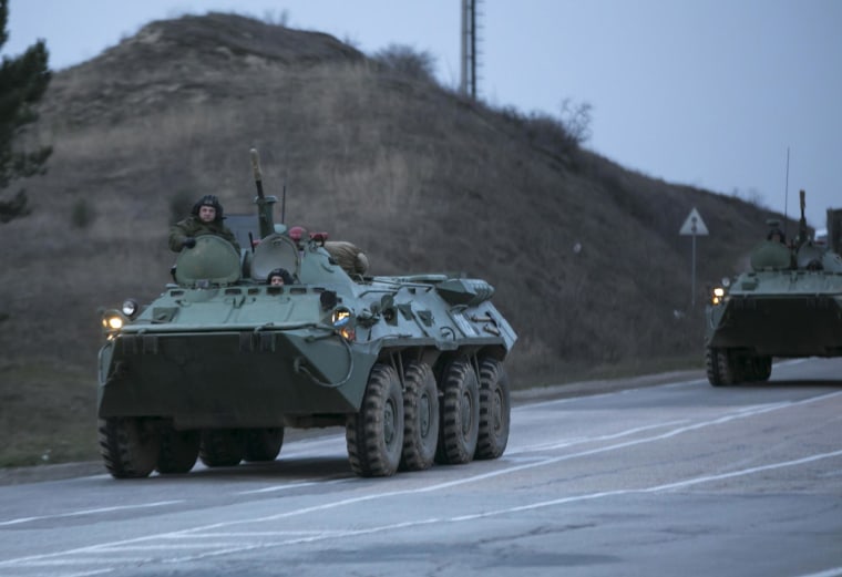 Image: Russian military armoured personnel carriers (APC) drive on the road from Sevastopol to Simferopol