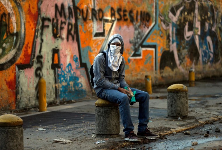 Image: A demonstrator takes a break in Caracas, Venezuela