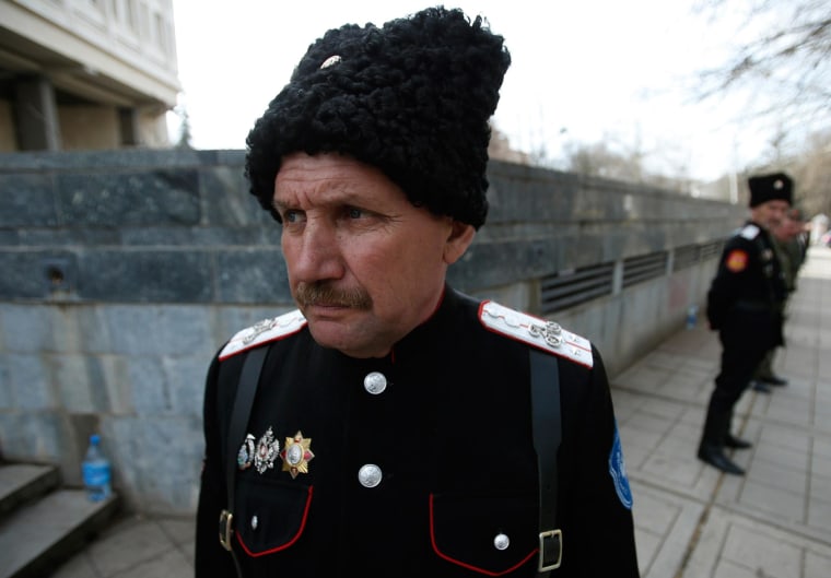 Image: Cossacks stand guard at the Crimean parliament building in Simferopol