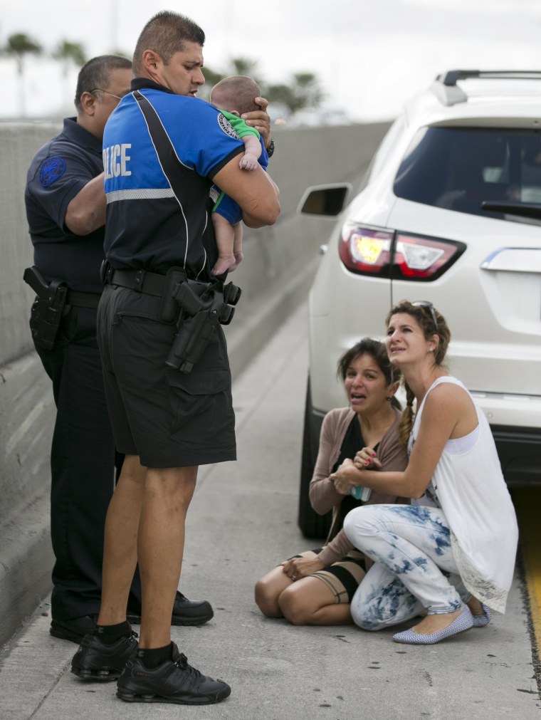 Image: Sweetwater officer Amauris Bastidas helps rescue a five-month-old baby boy