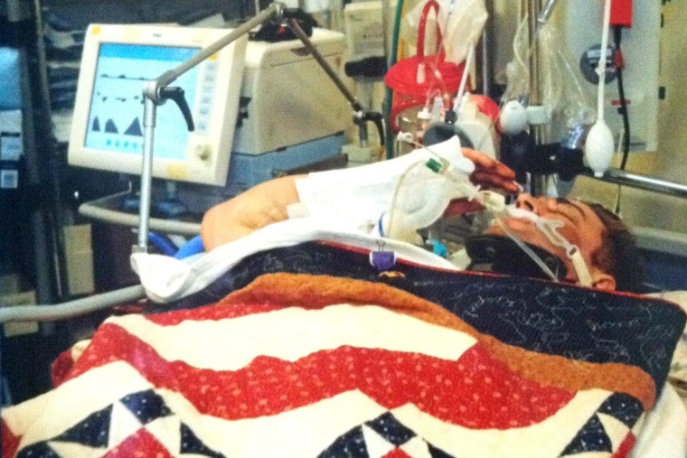 Sgt. Josh Hargis salutes from his field hospital bed in Afghanistan.
