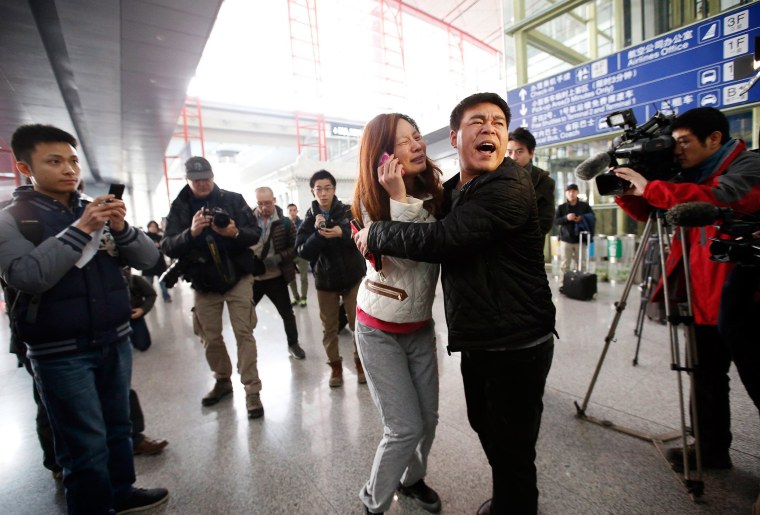 Image: A woman, believed to be the relative of a passenger onboard Malaysia Airlines flight MH370, cries at the Beijing Capital International Airport