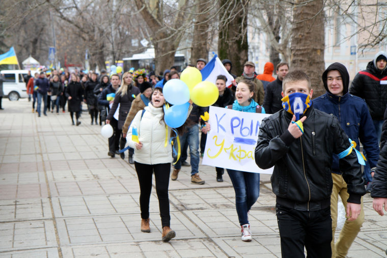 The first big street demonstration by about 100 pro-Ukrainian supporters march through a city park in Simferopol, Crimea, on Saturday.