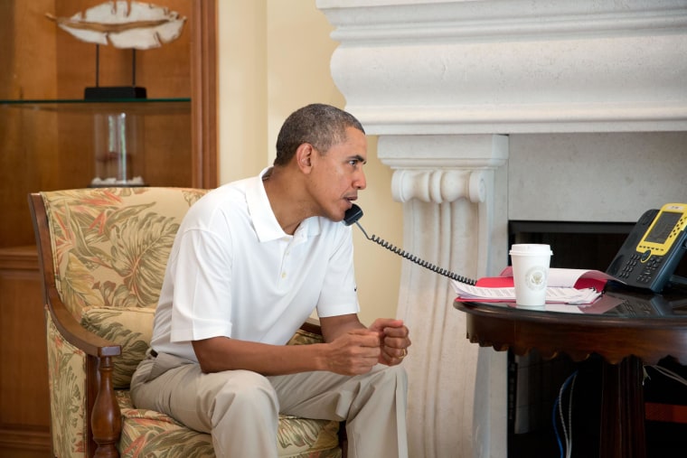 Image: President Barack Obama talks on the telephone with President Francois Hollande of France to discuss the situation in Ukraine