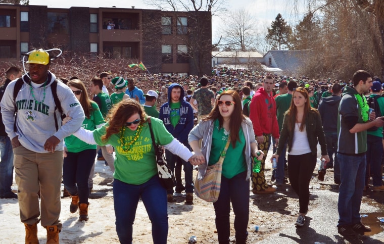 Image: People gather for the pre-St. Patrick's Day "Blarney Blowout" near the University of Massachusetts in Amherst