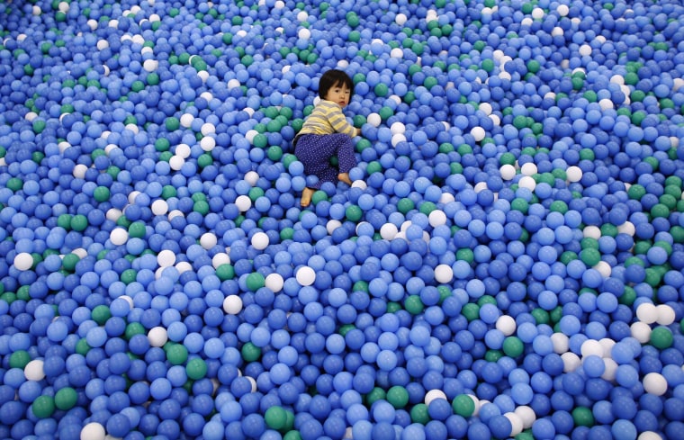 Image: Two-year-old Nao Watanabe plays in a ball pit at an indoor playground which was built for children and parents who refrain from playing outside because of concerns about nuclear radiation in Koriyama.