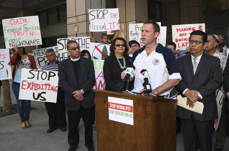Brent Wilkes, national executive director of the League of United Latin American Citizens, speaks as demonstrators protest against Herbalife, a nutrition and supplements company, outside the Ronald Reagan State Office building in Los Angeles on October 18, 2013.