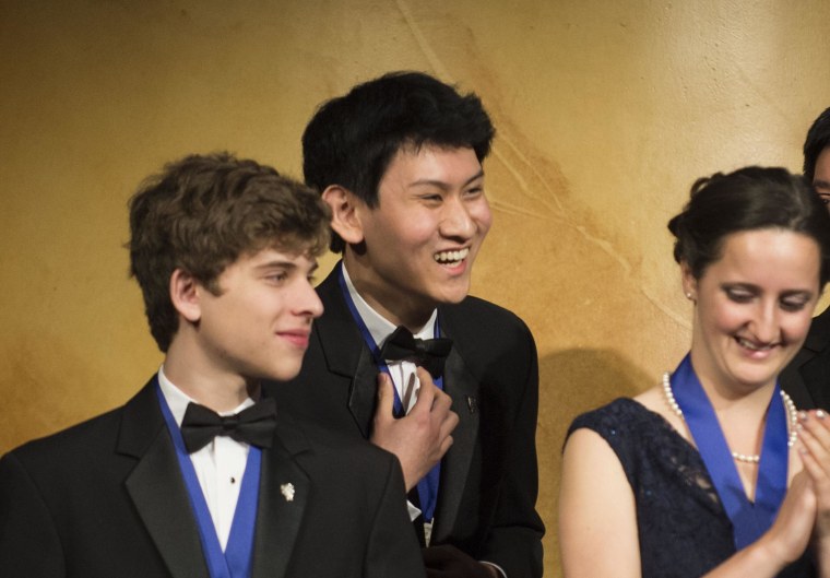 San Diego high schooler Eric Chen, 17, (center) won first-place and $100,000 in the Intel Science Talent Search.