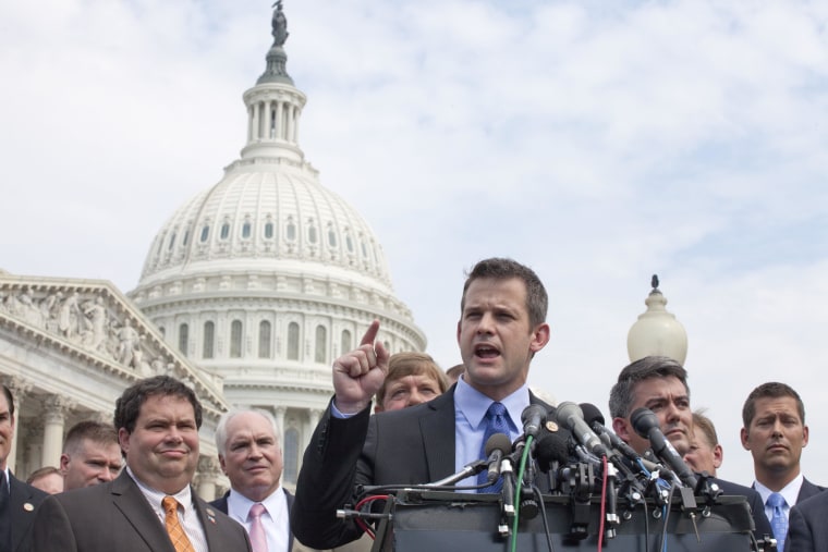 Rep. Adam Kinzinger, R-Ill., accompanied by fellow  freshmen House members, gestures during a news conference on Capitol Hill in Washington on Thursday, July 28, 2011, to announce they'll vote yes later Thursday on the GOP plan to raise the debt limit. Rep. Blake Farenthold, R-Texas is second from left, Rep. Cory Gardner, R-Colo. is second from right, Rep. Sean Duffy, R-Wis. is at right. (AP Photo/Harry Hamburg)