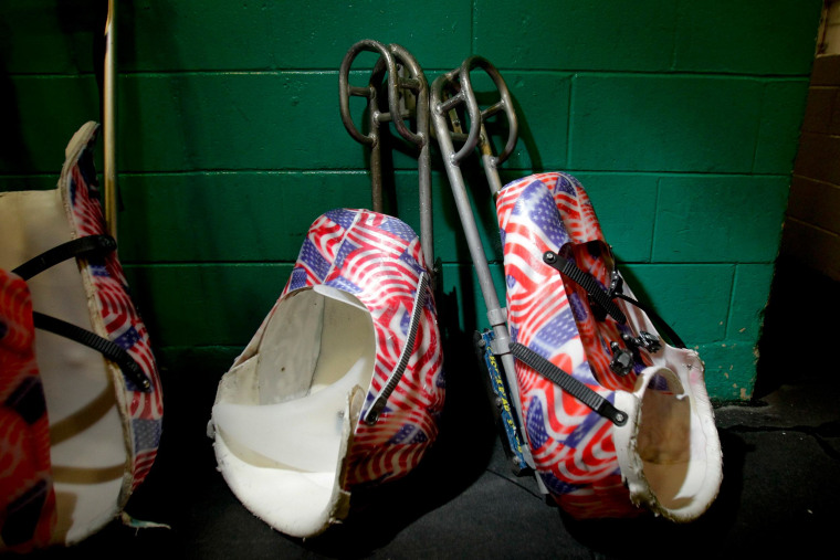 Image: Sleds lean against the wall outside the team's locker room