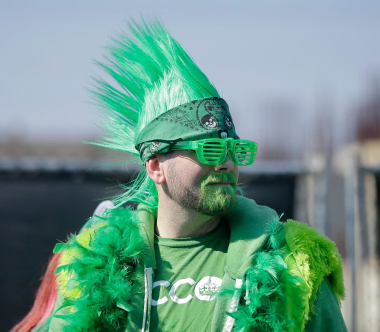 Image: A fan is dressed in green to watch a St. Patrick's Day parade Sunday in Asbury Park, N.J.