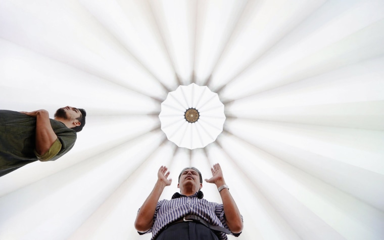 Image: Muslims attend Friday prayers at the National Mosque in Kuala Lumpur