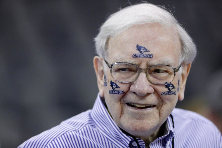 Billionaire investor Warren Buffett wears Creighton University stickers at NCAA college basketball game in Omaha, on March 8. His advice is to study the form to win the $1 billion March Madness perfect bracket contest.
