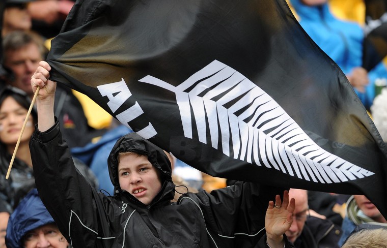 Image: All Blacks fan holds a flag