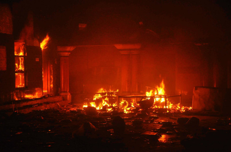 Image: A Hindu temple burns after it was attacked in Larkana