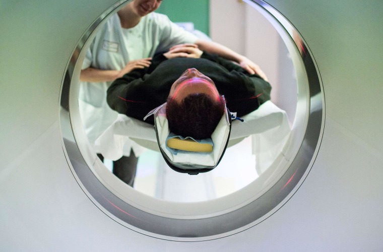 Image: A patient enters a computerized tomography (CT) scan.