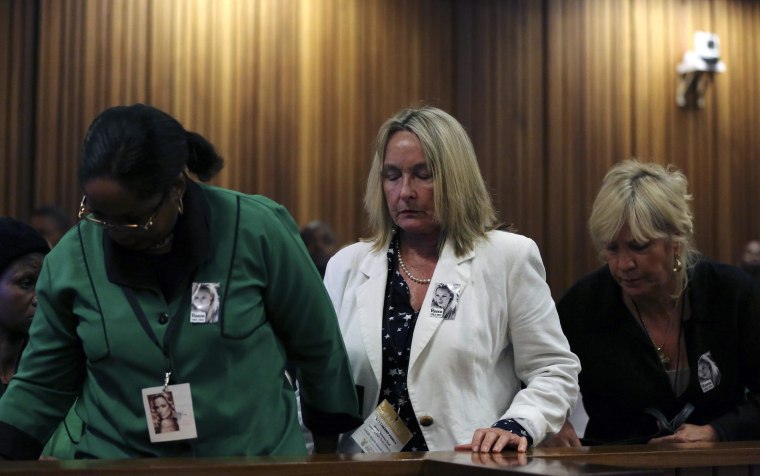 Image: June Steenkamp leaves the room as crime scene photos are shown