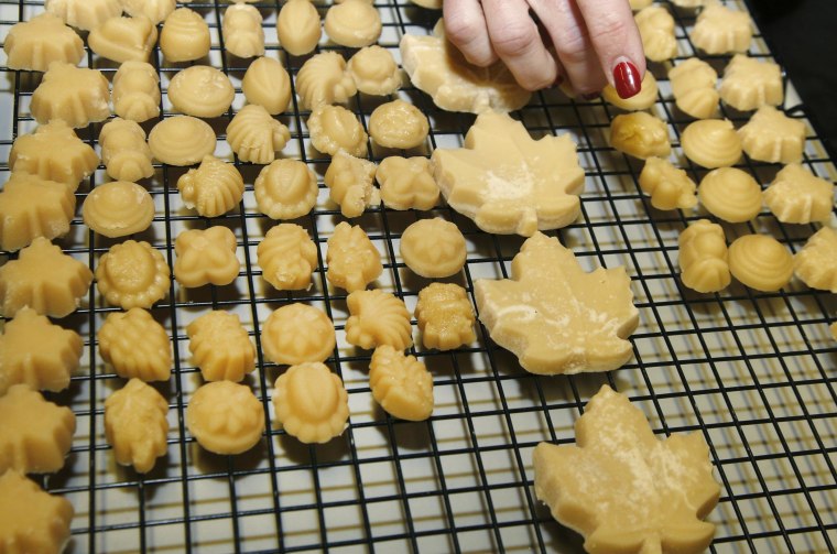 Image: Kathy Gallagher places maple sugar candy on a drying rack at the Turtle Lane Maple sugar house in North Andover, Mass. on March 14.