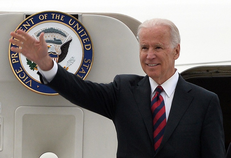 Image: Vice President Joe Biden waves as he leaves his plane after arriving in Warsaw, Poland