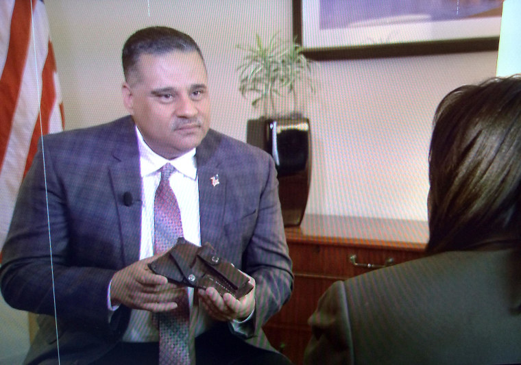 Richard Conde, the son of deceased Puerto Rican Staff Sgt Felix Conde-Falcon, holds the holster given to him by a soldier in his father's company. Conde-Falcon is one of several Latino soldiers to receive a posthumous Medal of Honor at a March 18, 2014 ceremony.