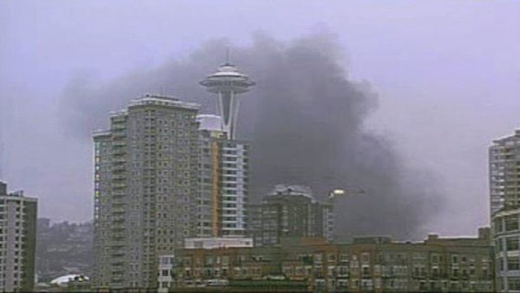 Smoke rises near the Space Needle in Seattle after the crash of a news helicopter