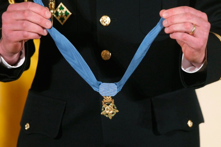 A military honor guard holds the Medal of Honor during a ceremony at the White House.