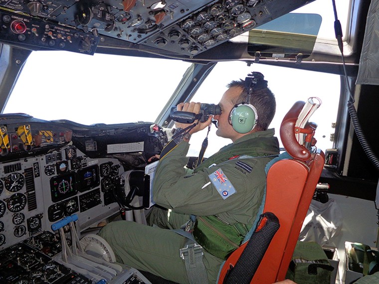 Image: A Royal Australian Air Force pilot of an AP-3C Orion maritime patrol aircraft scanning the surface of the sea near the west of Peninsula Malaysia