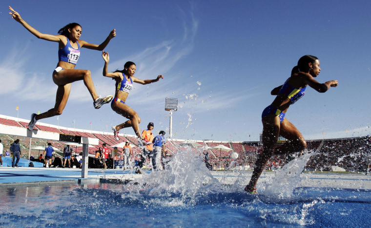 Image: A group of athletes competes in the women's 3,000 meters hurdle jump during the 10th ODESUR Games at National Stadium in Santiago, Chile