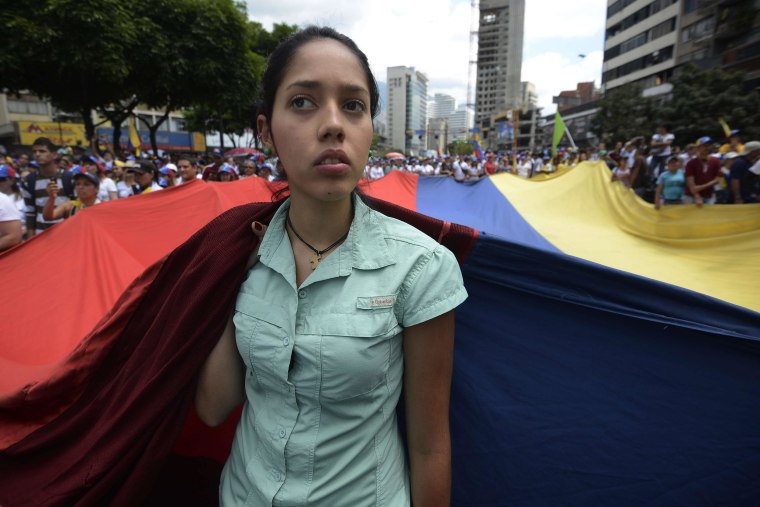 Opposition activists march toward the Cuban embassy to protest against Cuban interference in Venezuela's internal affairs and against the government of President Nicolas Maduro