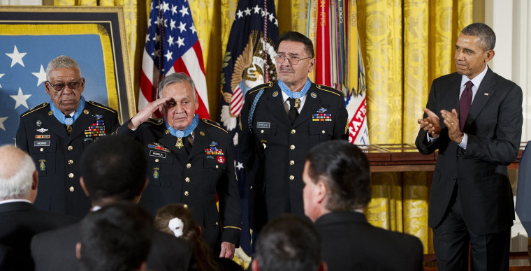 Image: President Barack Obama applauds Medal of Honor recipients Staff Sergeant Melvin Morris, left, Sergeant First Class Jose Rodela, second left, and Specialist Four Santiago Erevia, third left, for actions during the Vietnam War, during a ceremony in t