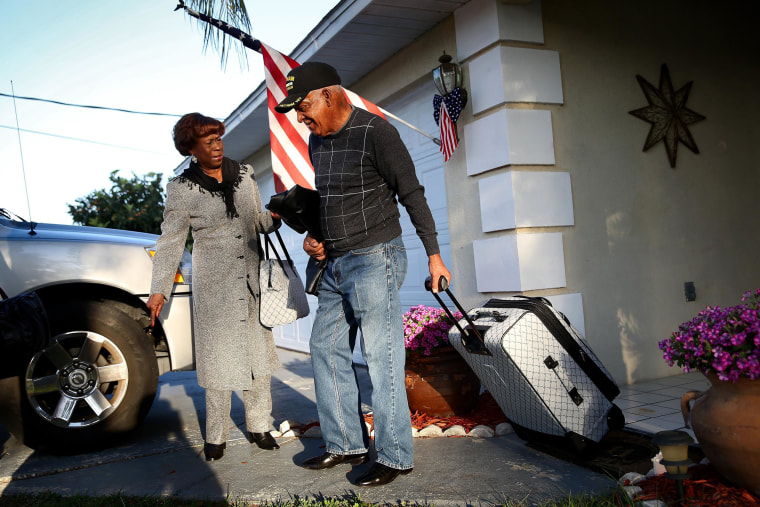 Image: U.S. Army Staff Sergeant Melvin Morris, a Vietnam War veteran, and his wife, Mary Morris, leave their house on their way to Washington, DC