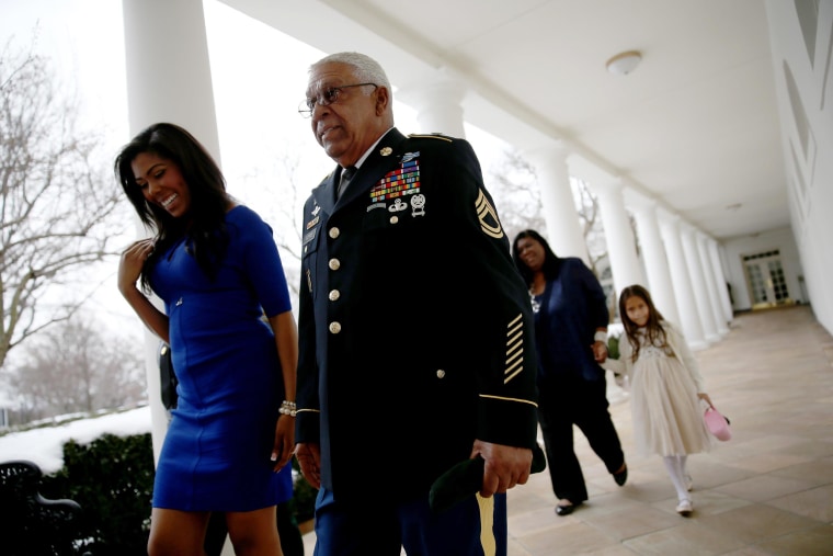 Image: U.S. Army Staff Sgt. (Ret.) Melvin Morris,  a Vietnam War veteran, walks with his granddaughter,  Symone Barnes, after they met President Barack Obama in the Oval Office and before a ceremony to award him the Medal of Honor