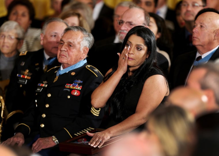 Image: Medal of Honor recipient U.S. Army Sgt. First Class (Ret.) Jose Rodela, left, a Vietnam War veteran, sits next to Lenora Alvarado who wipes away tears after accepting the Medal of Honor on behalf of her father, Vietnam War veteran Specialist Four L