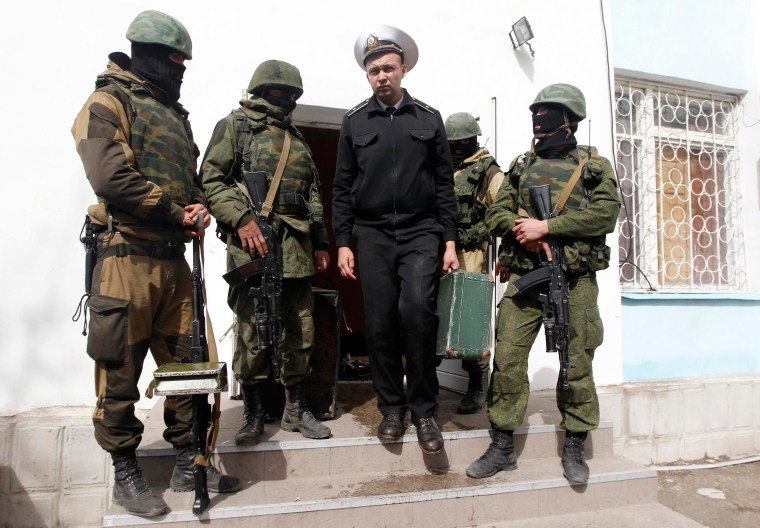 Image: A Ukrainian naval officer leaves the naval headquarters in Sevastopol